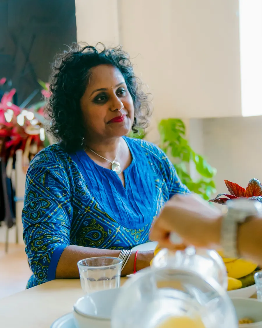 A woman sitting at her kitchen table at home over breakfast.